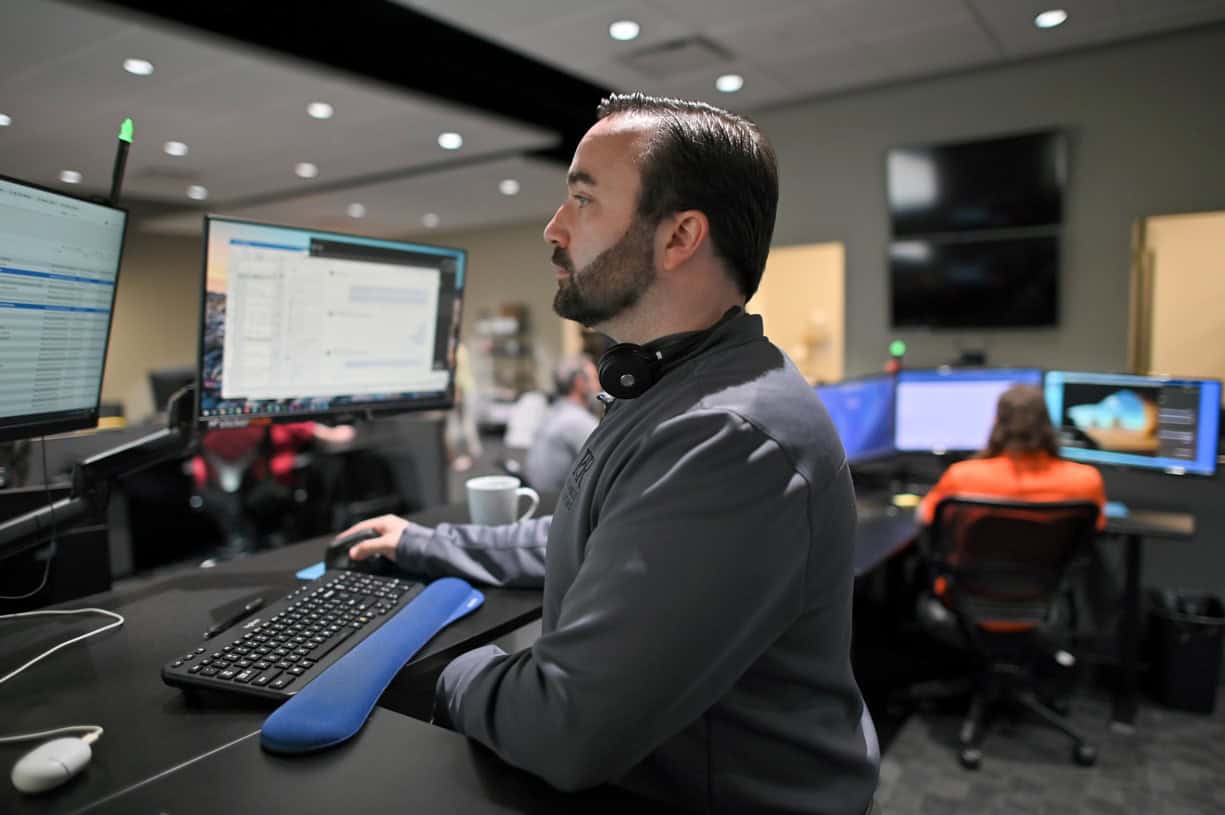 Akron IT support team working on Akron discussing practical AI solutions